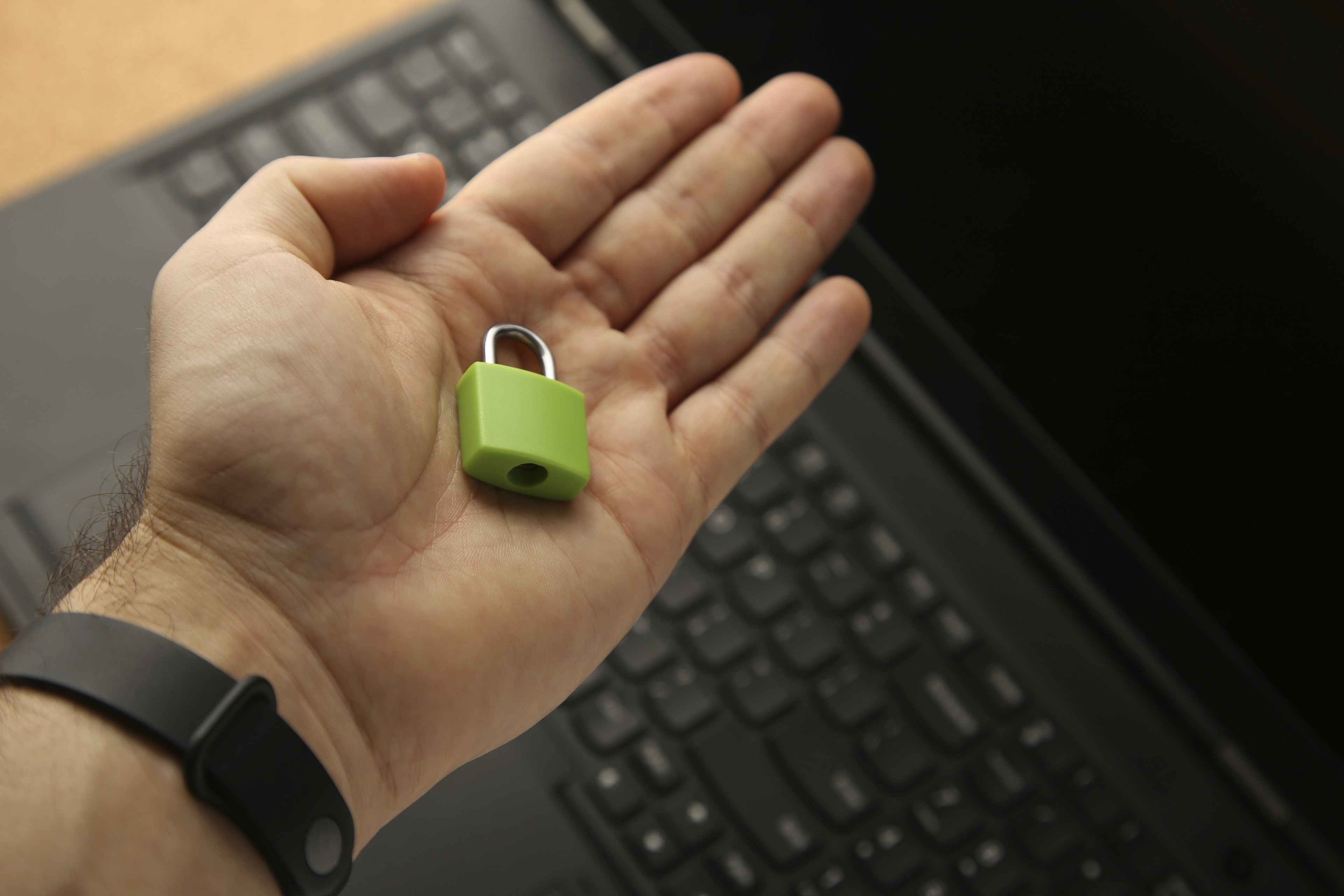 Hand Holding Green Padlock With Laptop Background Cyber Security Concept