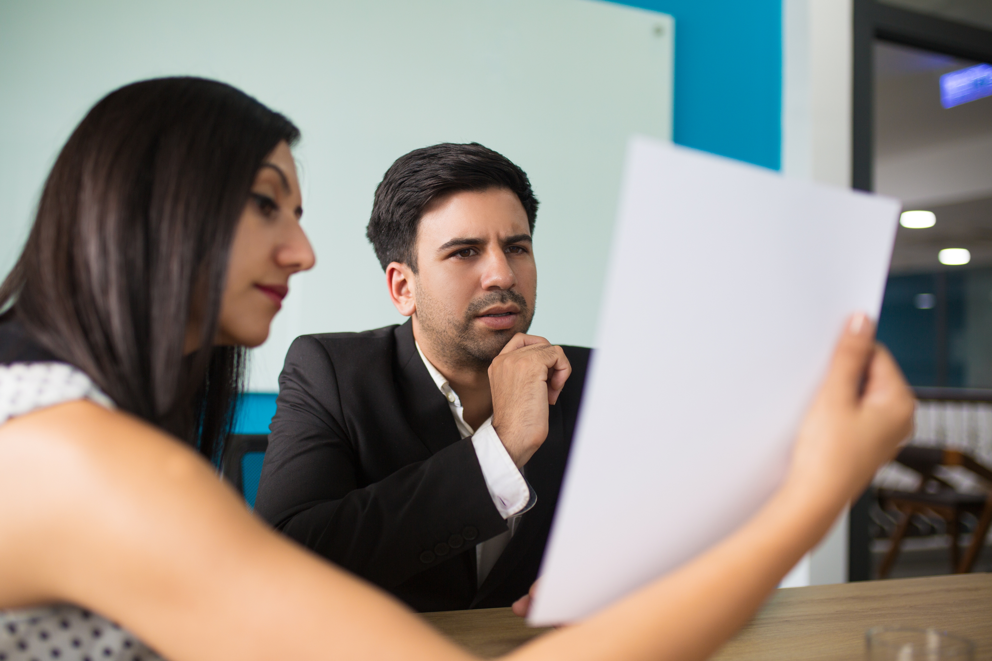 Young Female Secretary Showing Document Puzzled Executive